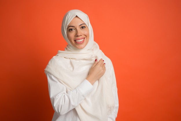 happy-arab-woman-hijab-portrait-smiling-girl-posing-red-studio-background-young-emotional-woman-human-emotions-facial-expression-concept-front-view_155003-22795